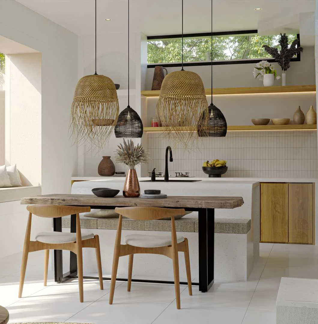 Kitchen with rattan pendants over a round table, open shelves, a window of green.